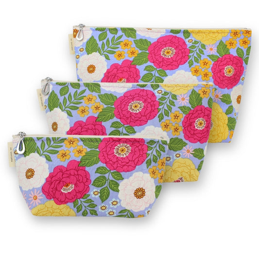 Set of three fuchsia and periwinkle floral-patterned pouches on a white background