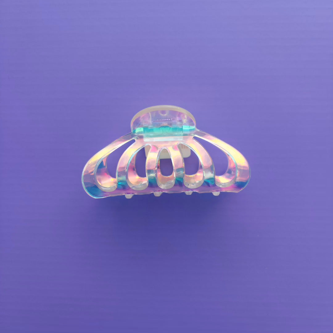 Iridescent hair clip on a purple background