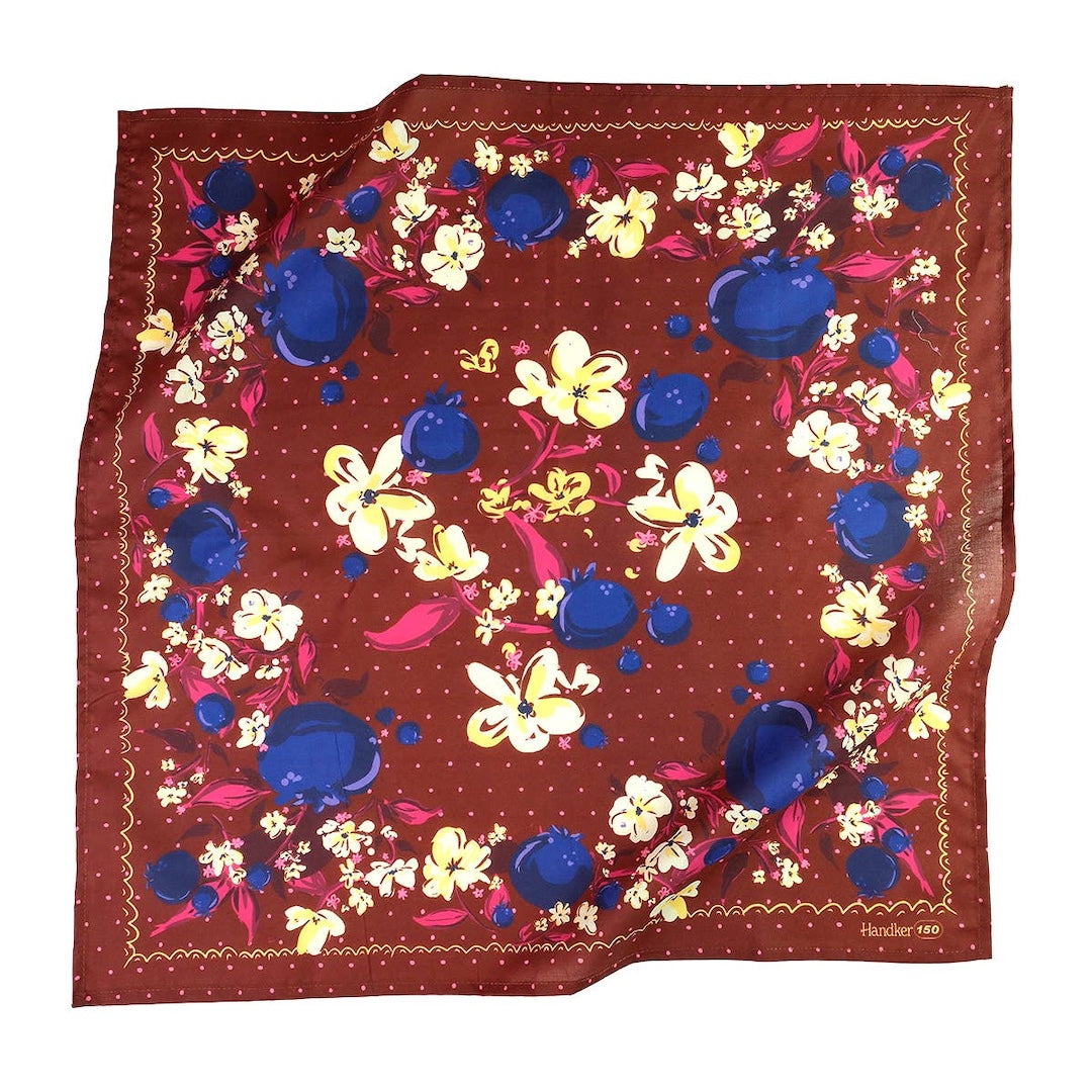 Floral patterned bandana with blueberries, yellow, and pink flowers on a brown background