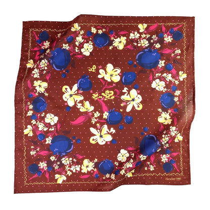 Floral patterned bandana with blueberries, yellow, and pink flowers on a brown background