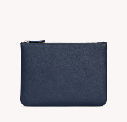 A navy blue vegan leather zip pouch with a silver zipper pull, shown against a plain off-white background.