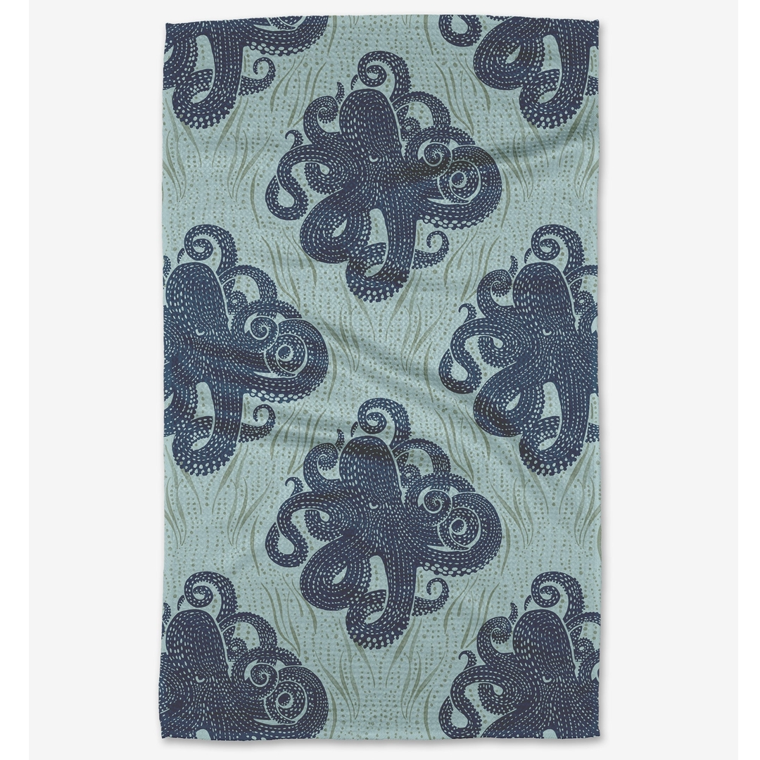 Teal towel with navy blue octopus pattern on a white background