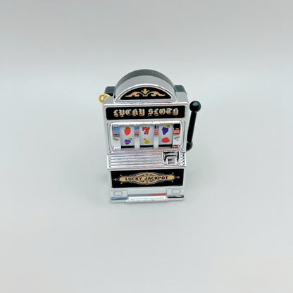 Miniature slot machine-shape with 'Lucky Seven' on a light gray background