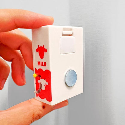 The back of a vending machine magnet showing the magnet and the little flap that opens that lets you load a mini soda into the machine