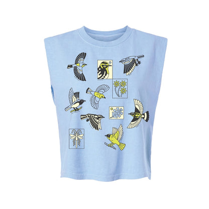 A light blue sleeveless t-shirt with a graphic print of warbler birds and flowers in yellow, black, and white, displayed on a solid white background.