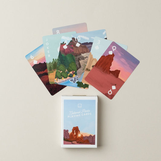 Set of playing cards with national park illustrations and a matching card box on a beige background