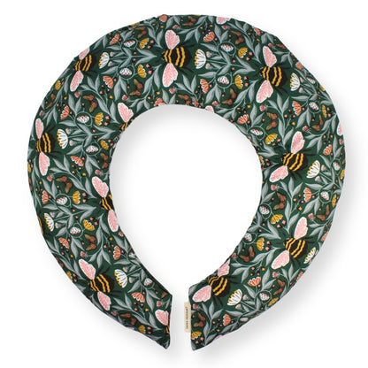 A padded fabric neck pillow with a dark green background and an all-over pattern of pink bees, butterflies, and leaves, shown on a clean white background.
