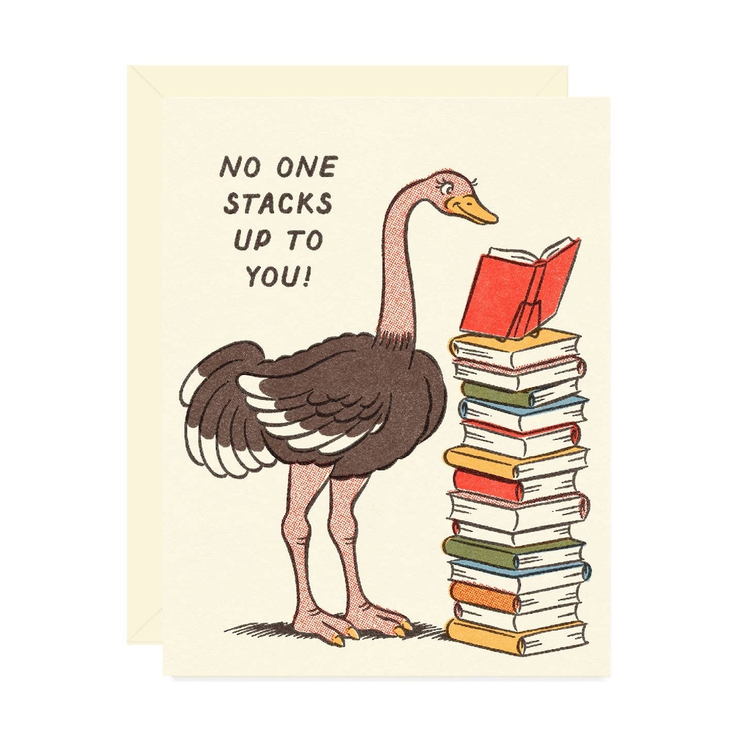 Greeting card with a cartoon ostrich and a stack of books and text 'No one stacks up to you!' on a beige background