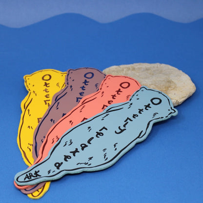 colorful otter shaped bookmarks that say "otterly relaxed"