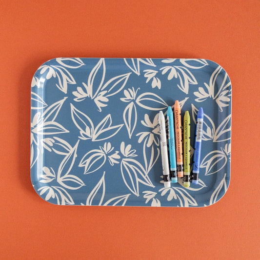 Blue tray with white leaf pattern on an orange background