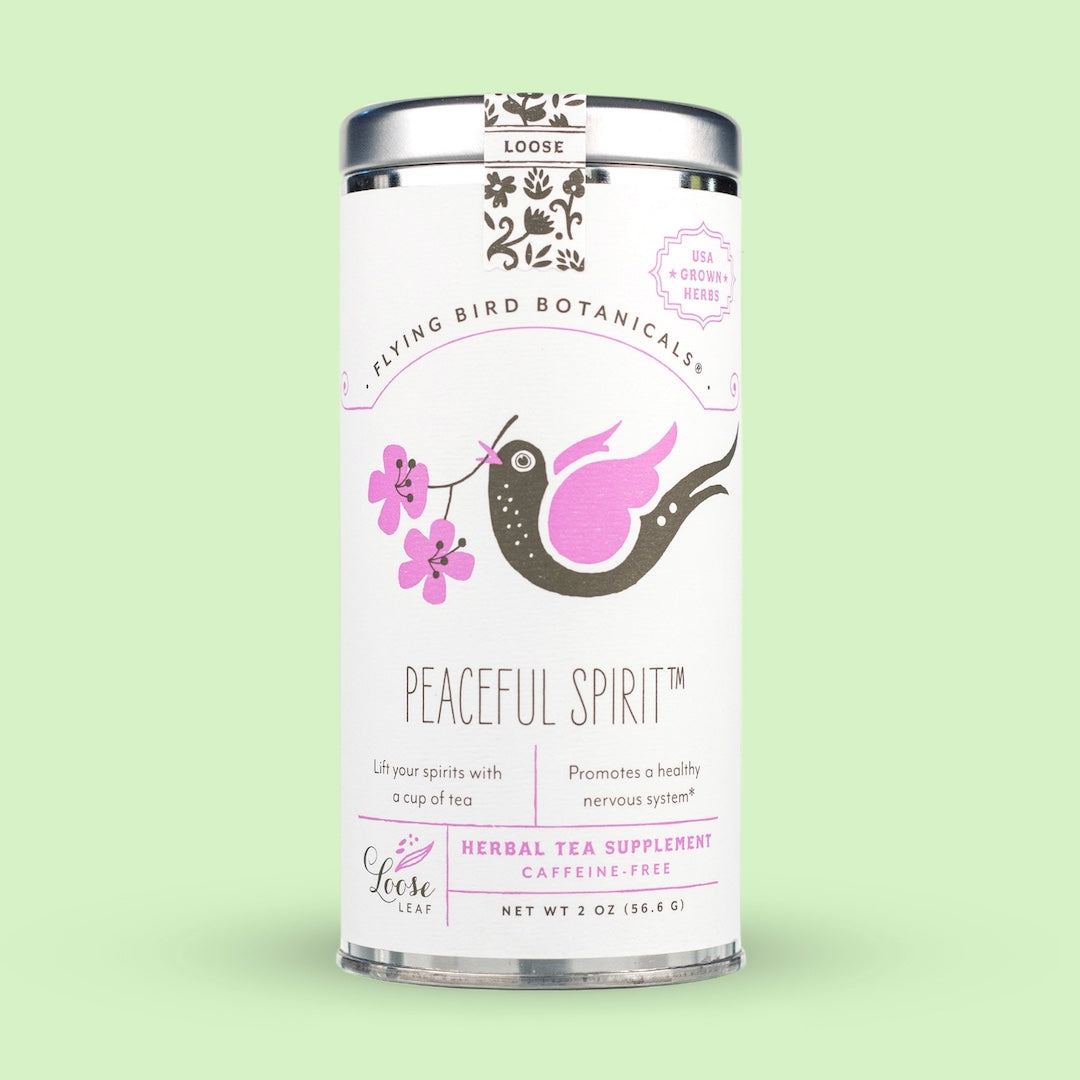 A tall cylindrical canister of Flying Bird Botanicals Peaceful Spirit herbal tea supplement, featuring a white label with a pink and brown bird illustration, set against a solid pale green background.