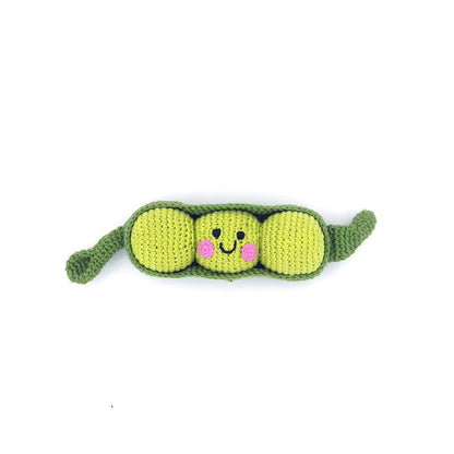 Crocheted toy shaped like a pea pod with a smiley face on a white background