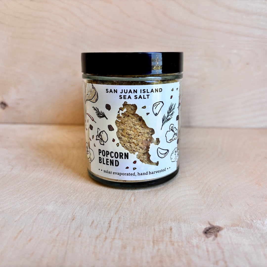Jar of San Juan Island Sea Salt Popcorn Blend on a wooden surface