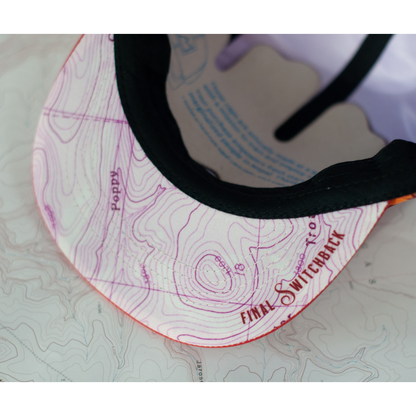 Close up of the underside of a cap's visor that features a topographical map and Final Switchback branding