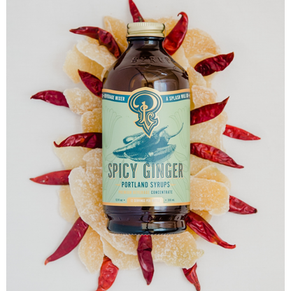 Spicy Ginger syrup bottle with ginger and red peppers on a white background