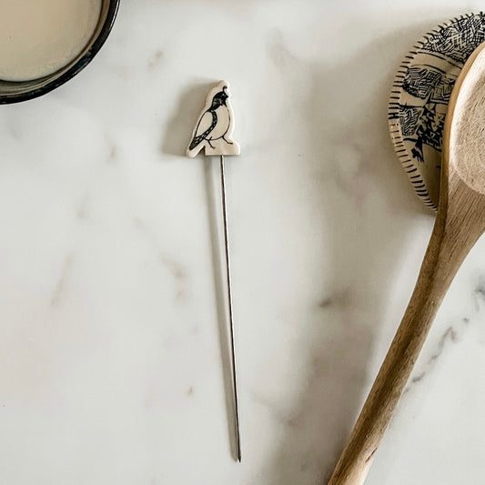 Baking stick with ceramic quail at the top