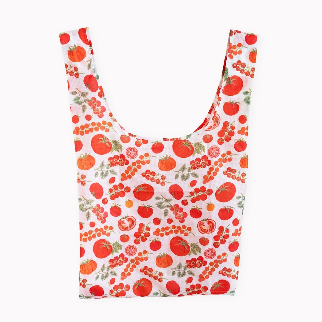 A reusable fabric shopping bag with a white background and an all-over print of red tomatoes shown against a plain white background.