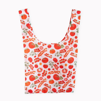 A reusable fabric shopping bag with a white background and an all-over print of red tomatoes shown against a plain white background.