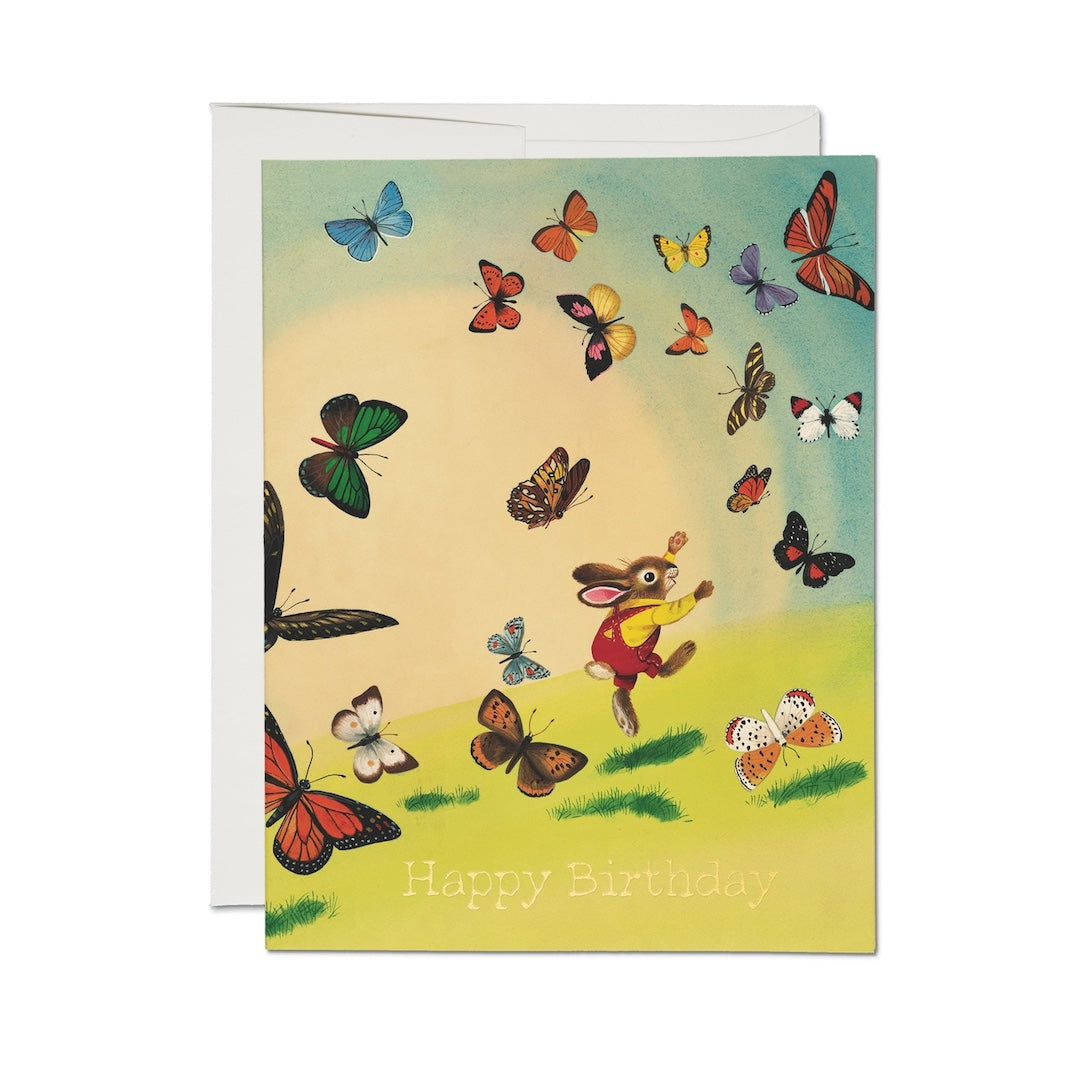Birthday card with a rabbit and butterflies design on a white background