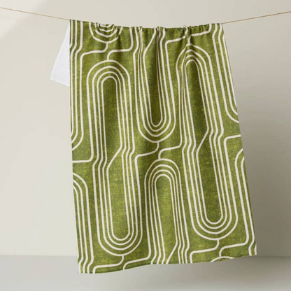 green dishtowel with an abstract pattern