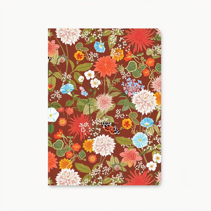 Notebook with a brown cover and a nature inspired pattern that features a moth, bright flower, and leaves. In the center of the cover "Notes" is written in gold. Shown on a white background.