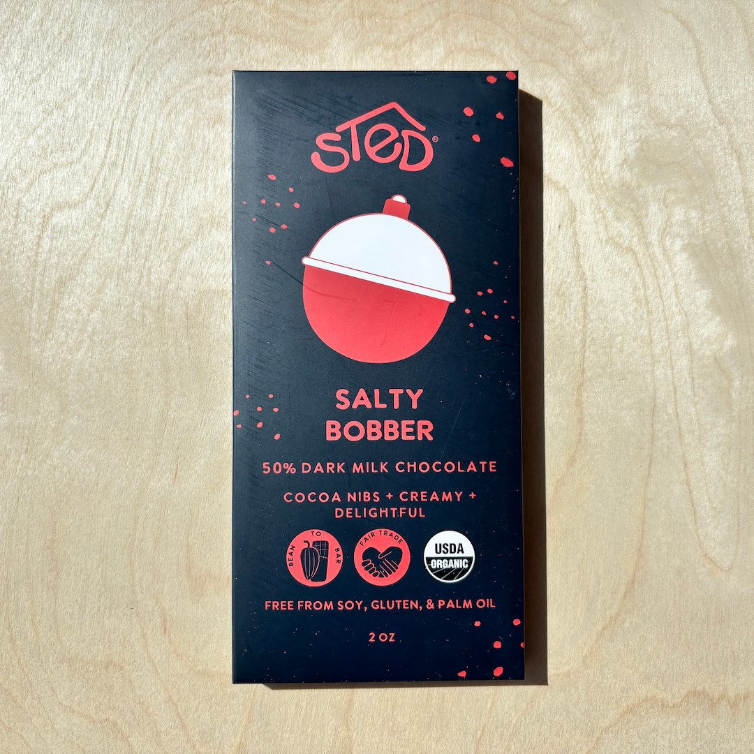 STED salty bobber chocolate bar  in packaging on a wooden surface
