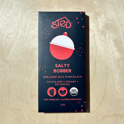 STED salty bobber chocolate bar  in packaging on a wooden surface