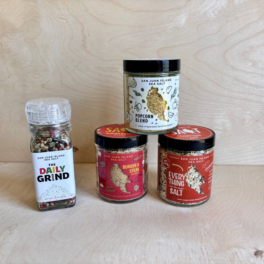 Collection of spice jars with labels on a wooden surface
