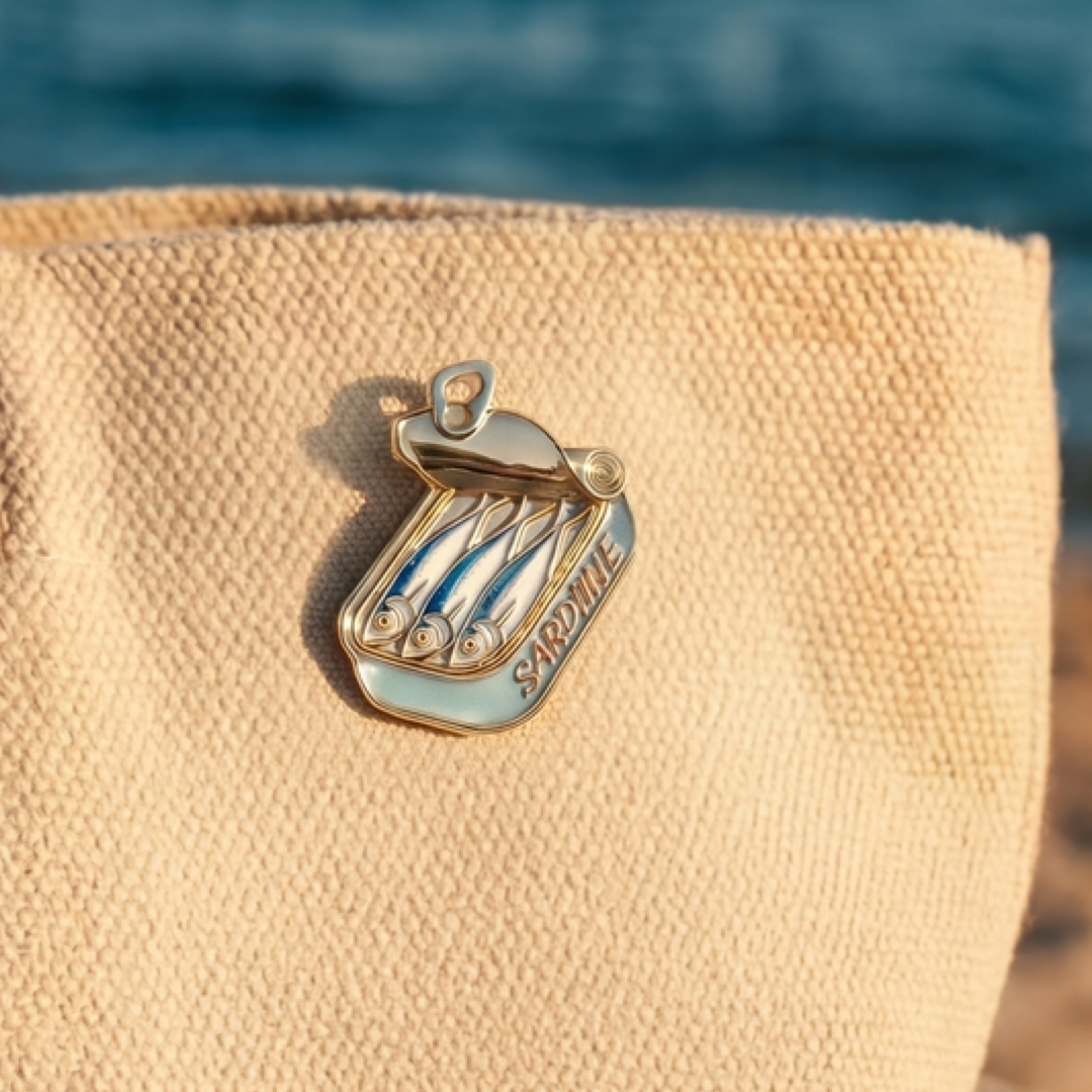 tin of sardines enamel pin on a beige tote