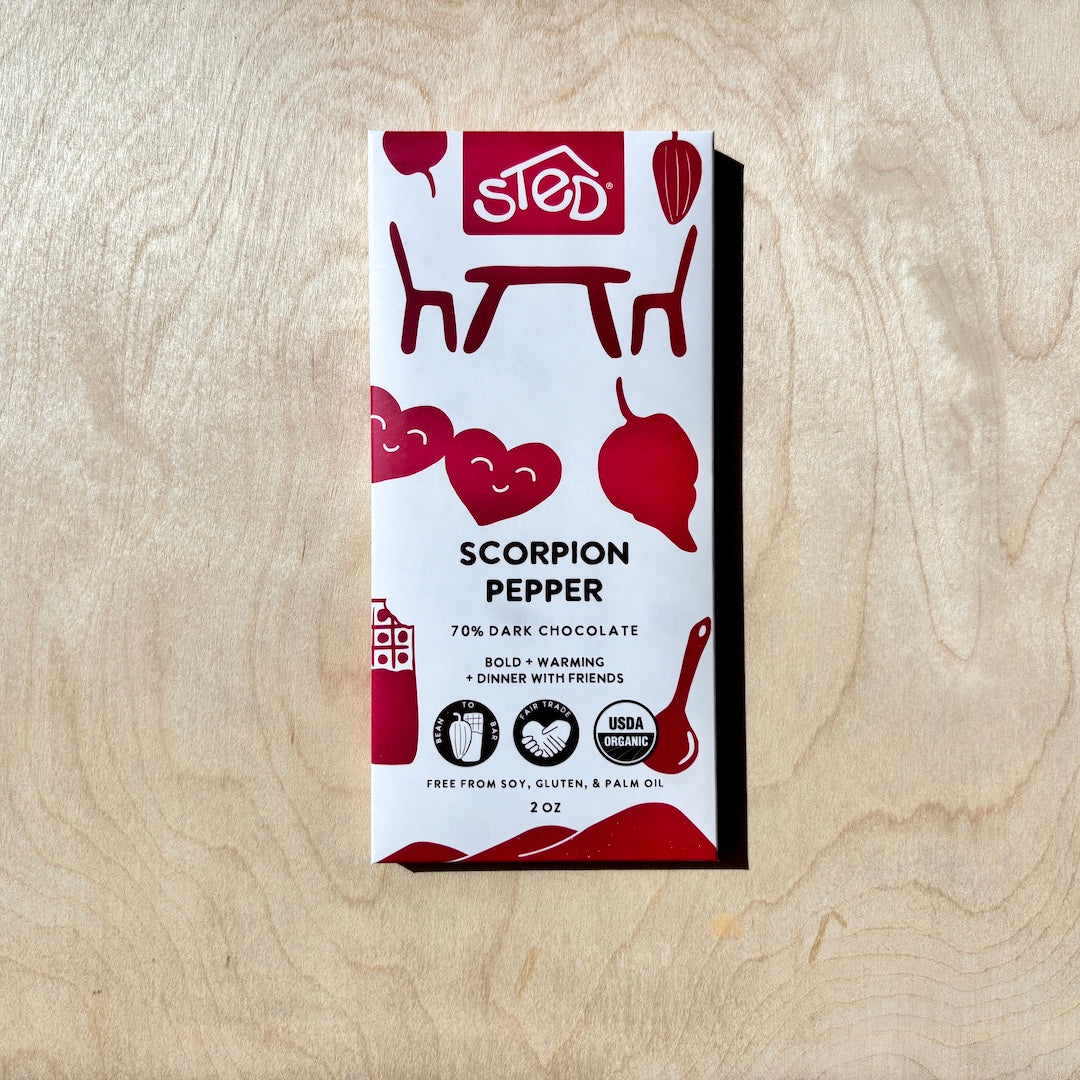 STED scorpion pepper chocolate bar in packaging on a wooden surface