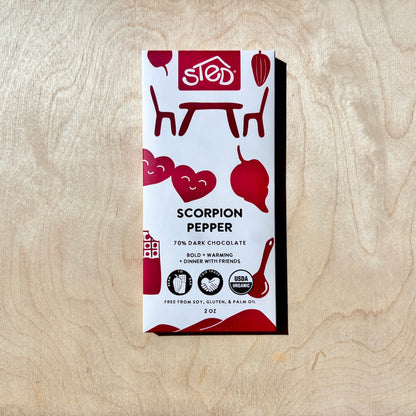 STED scorpion pepper chocolate bar in packaging on a wooden surface