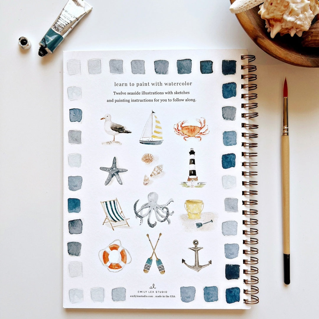 Spiral-bound notebook with watercolor illustrations of sea-themed objects