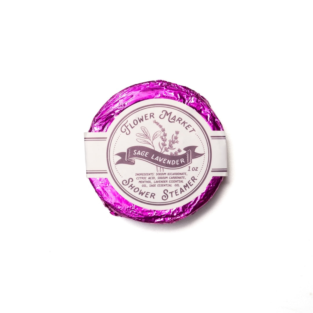 Round sage lavender scented shower steamer with 'Flower Market' branding on a white background