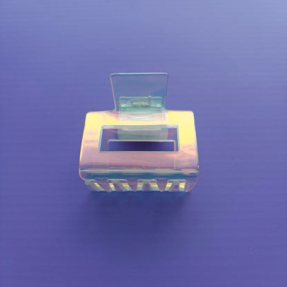 square iridescent claw clip on a purple background