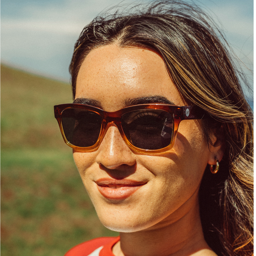 Woman wearing sunglasses with a blurred natural background