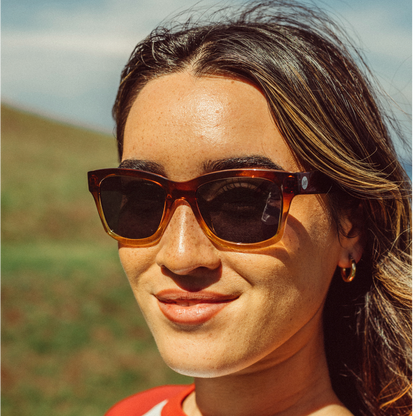 Woman wearing sunglasses with a blurred natural background