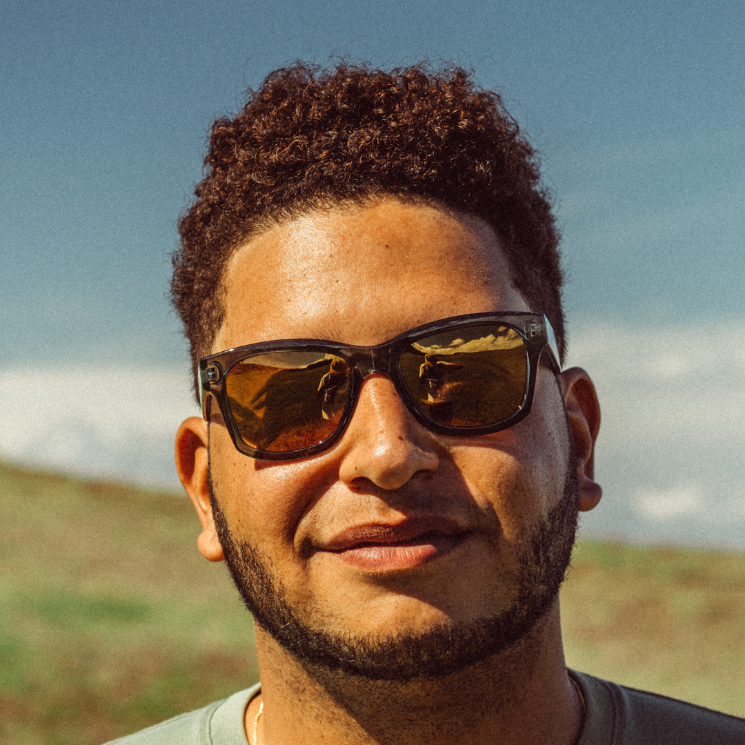 Man wearing sunglasses with a blurred natural background