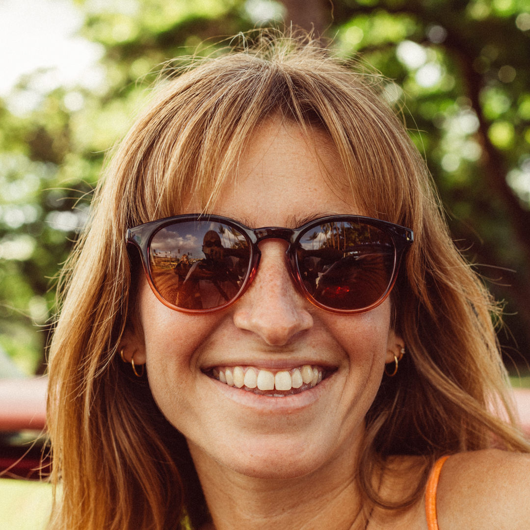 Woman wearing sunglasses with a blurred natural background