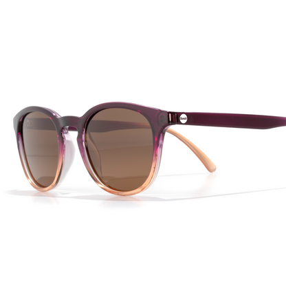 Sunglasses with a purple frame and brown lenses on a white background