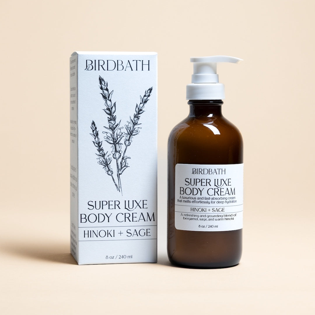 Birdbath Super Luxe Hinoki and Sage Body Cream bottle and packaging on a beige background