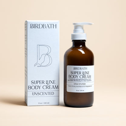 Birdbath Super Luxe Unscented Body Cream bottle and packaging on a beige background