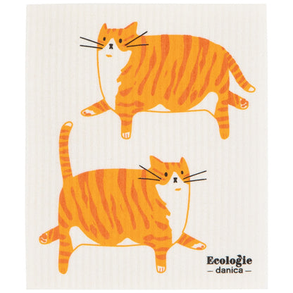 A white swedish dishcloth with two orange and yellow striped cartoon cats and the text 'Ecologíe danica' printed on it.