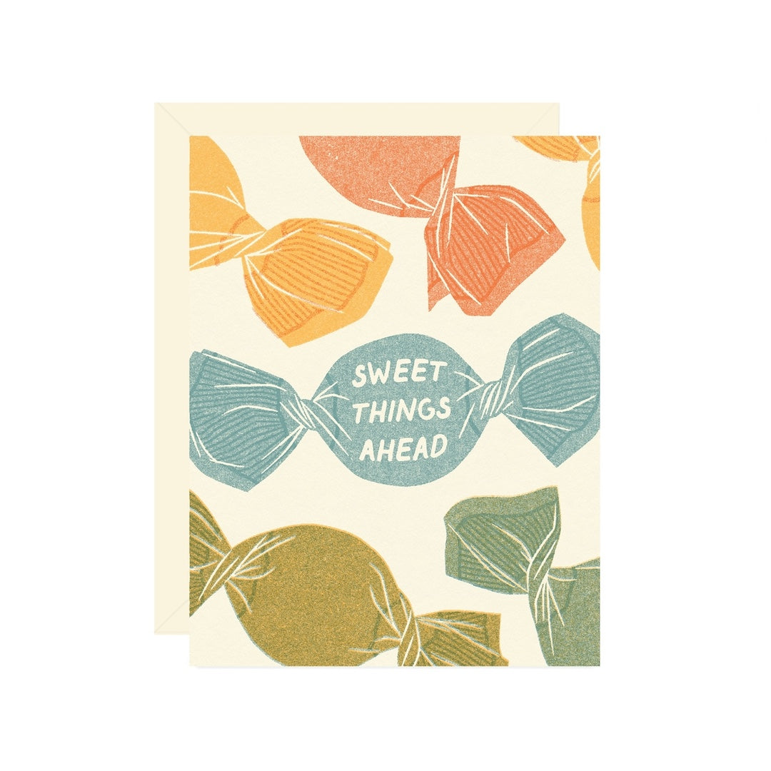 Greeting card with candy illustrations and 'Sweet Things Ahead' text on a beige background