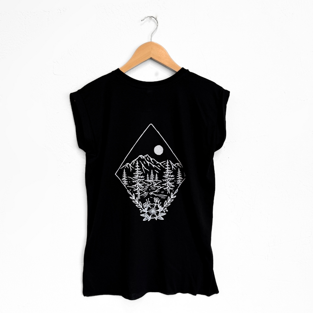black sleeveless shirt with a forest and mountain design on it.