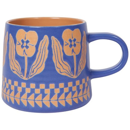 purple mug with orange floral patterns on a white background