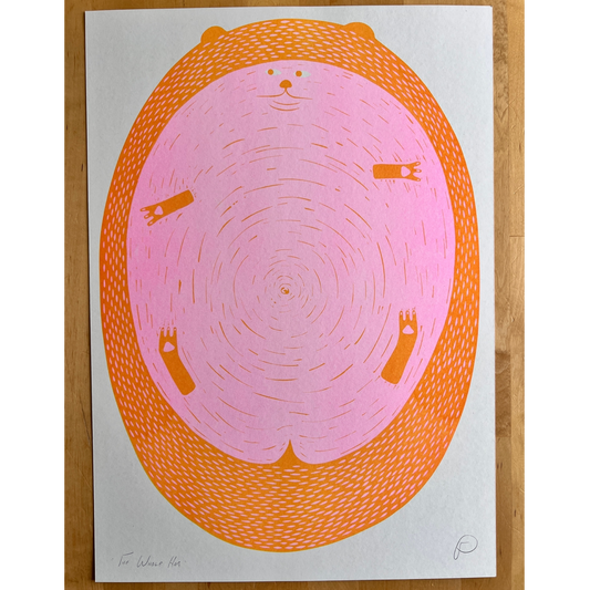A square art print featuring a stylized pig with an orange border, photographed flat against a light wood background.