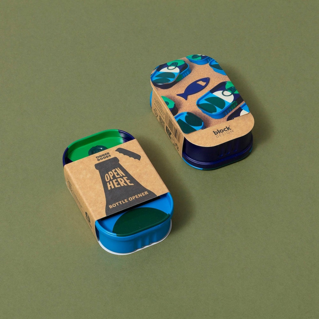 Blue bottle opener with cardboard packaging on a green background