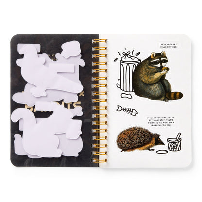 An open spiral-bound sticker book with animal stickers and text bubbles