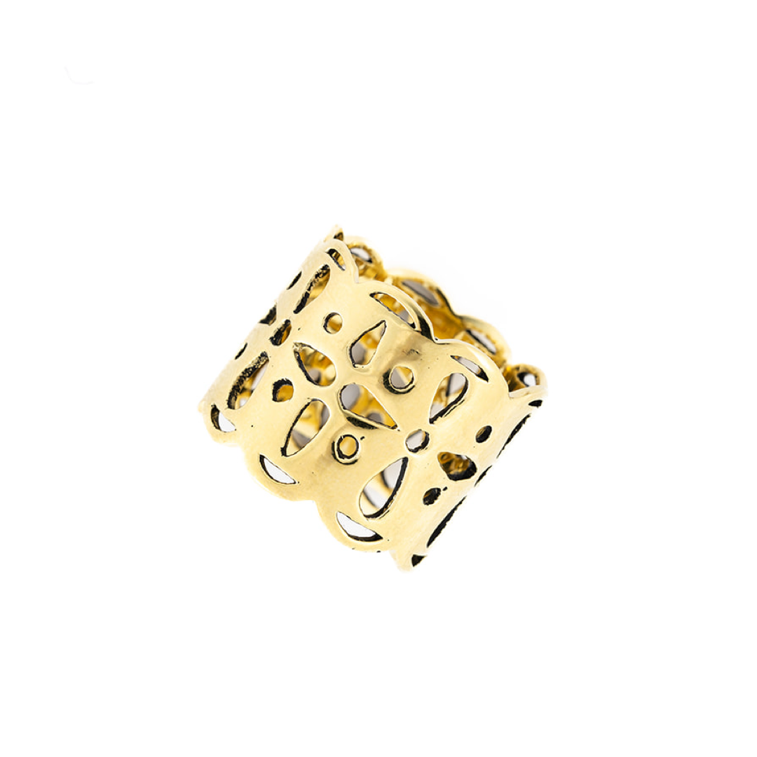 Brass bandana slide ring with intricate cut-out design on a white background