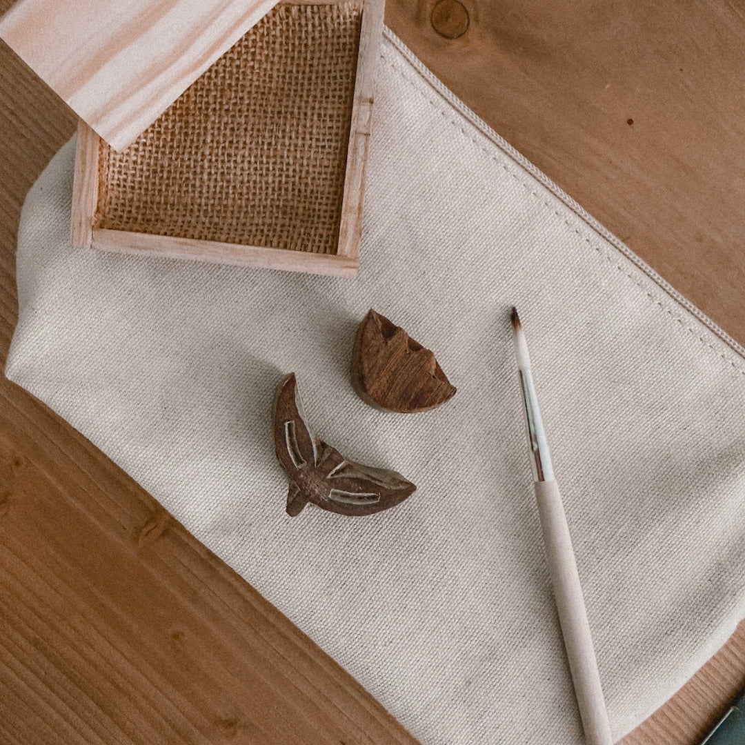 pine ink tray, one wooden block stamp shaped like a tulip flower and another wooden block stamp shaped like a tulip stem and leaves on a canvas pouch